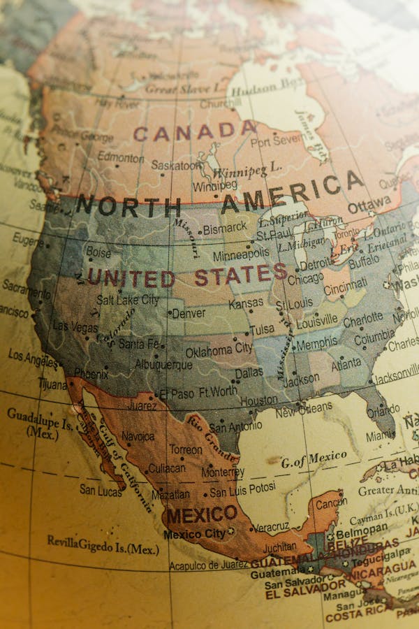 Photo by Lara Jameson Detailed close-up view of North America on a vintage globe showing countries and cities.