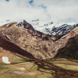 Explore the stunning snow-capped peaks of Mount Kazbek in Georgia with this breathtaking landscape.