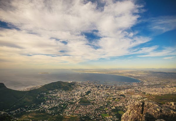 Photo by Scott Webb Stunning aerial view of Cape Town with the coastline, mountains, and blue sky.